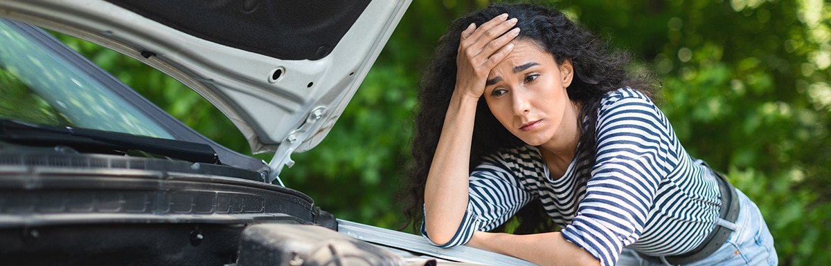Man on the phone with car bonnet open