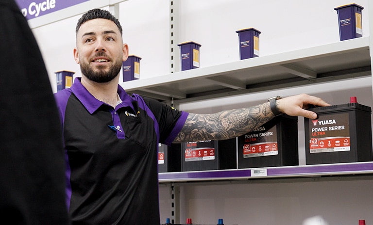 Battery world employee talking to customer